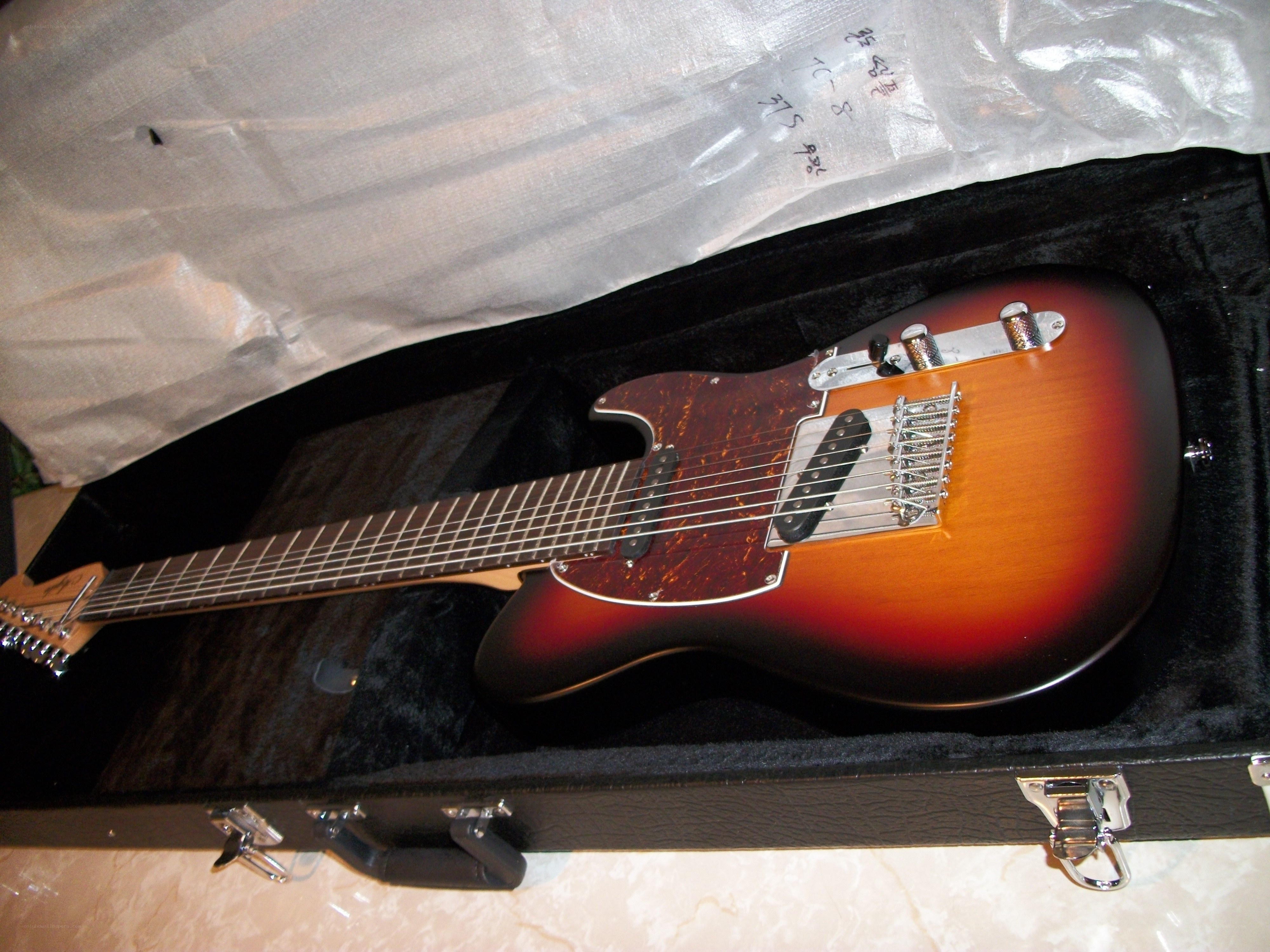 Sunburst electric guitar in case