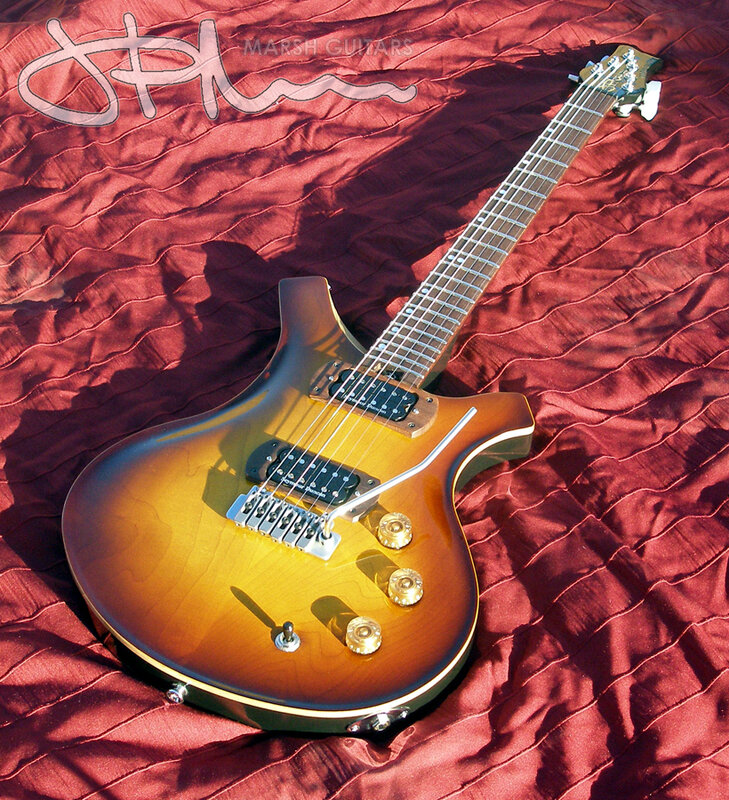 Sunburst electric guitar on red fabric