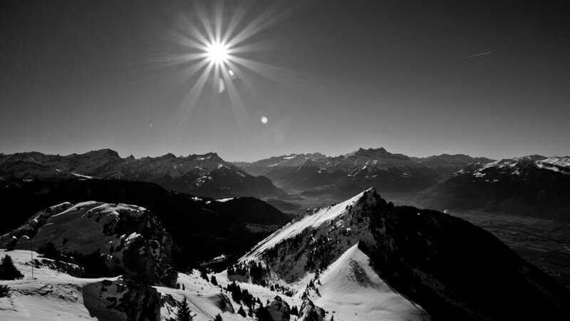 Sunburst over snowy mountains