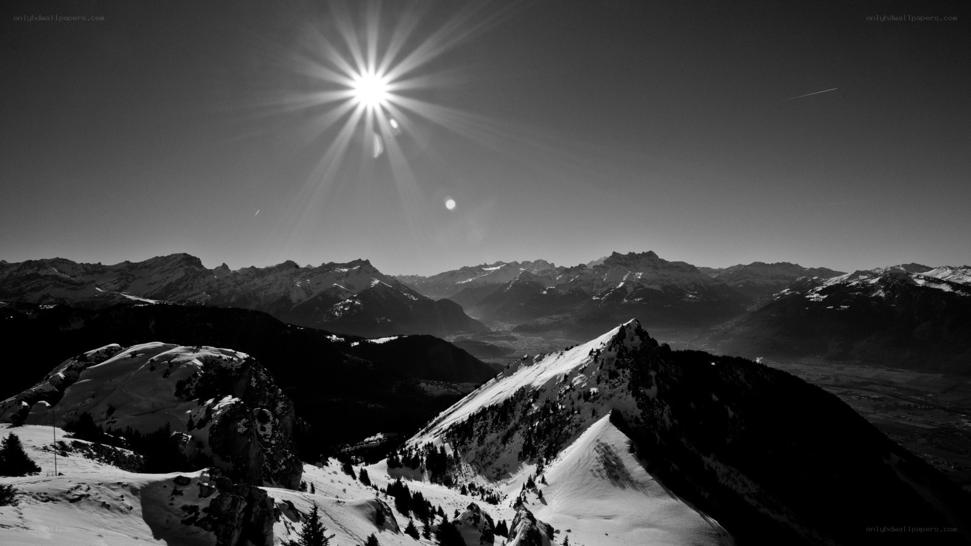 Sunburst over snowy mountains
