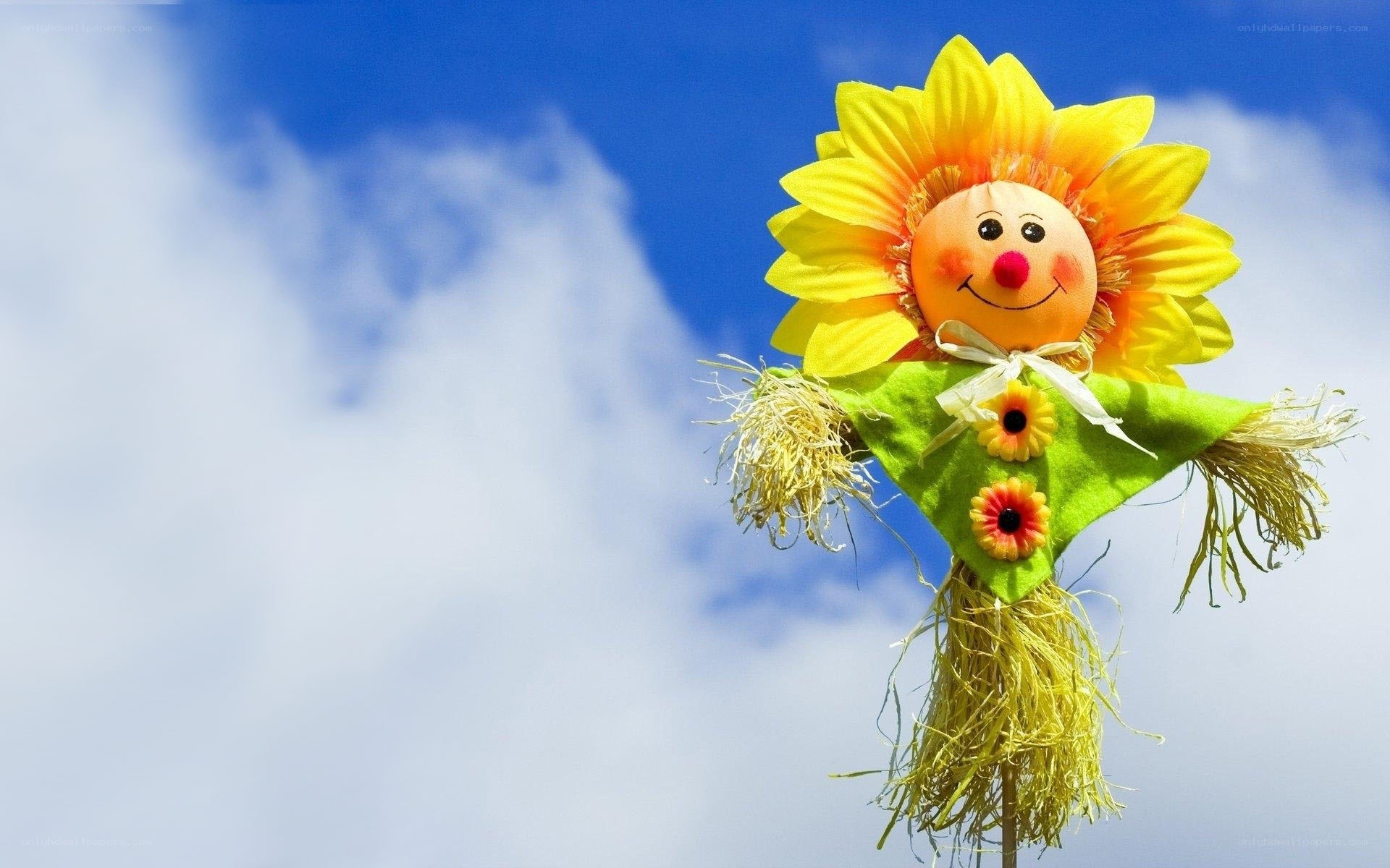 sunflower scarecrow against blue sky