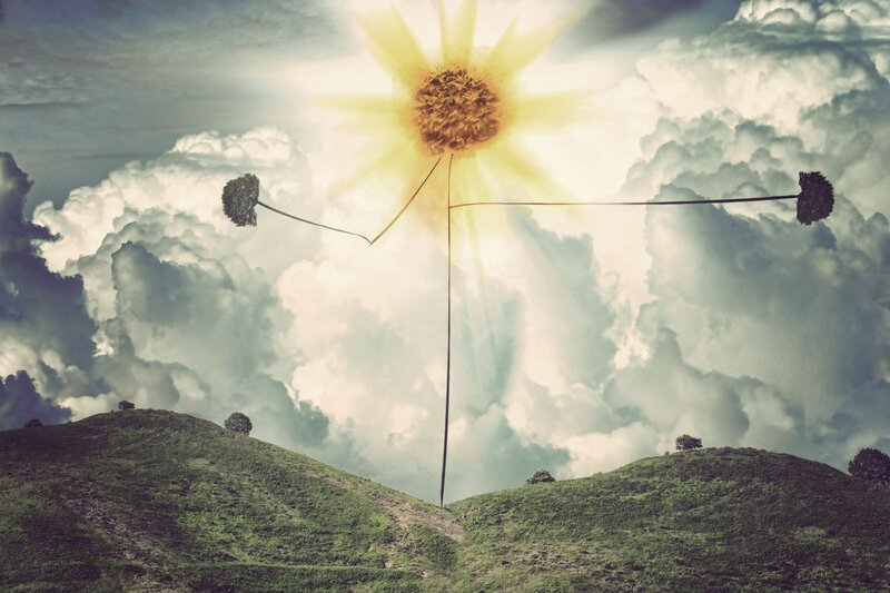Sunflower sun in cloudy sky
