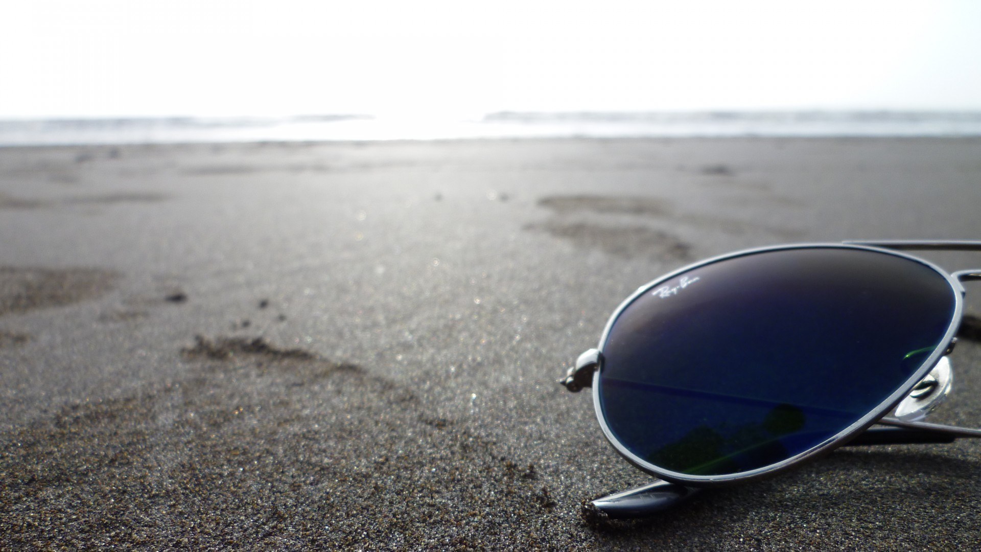 sunglasses on a sandy beach