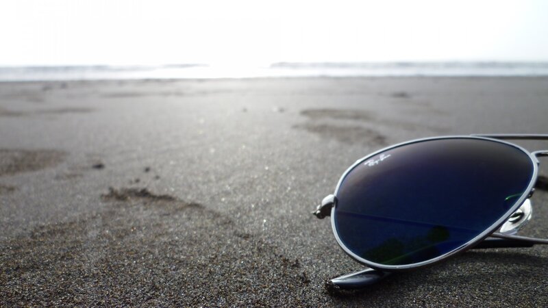 Sunglasses on Beach Sand — Gray