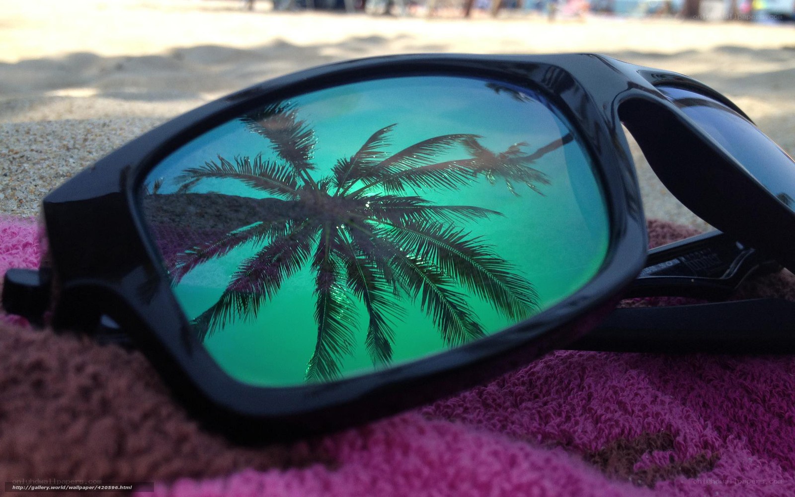 sunglasses on beach towel
