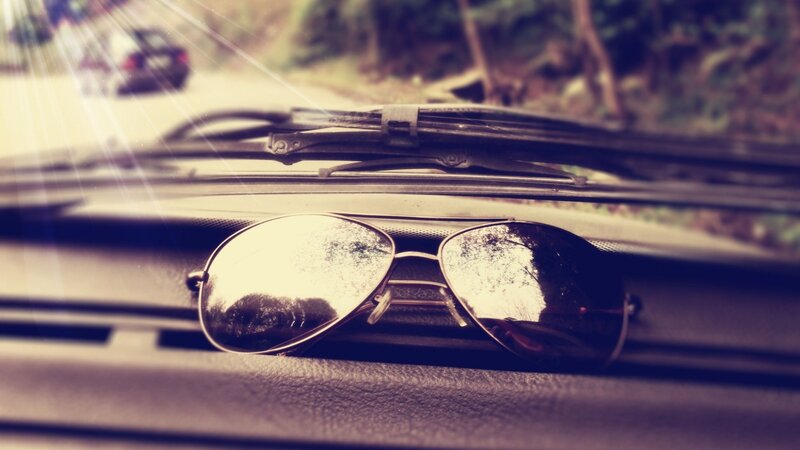 sunglasses on car dashboard
