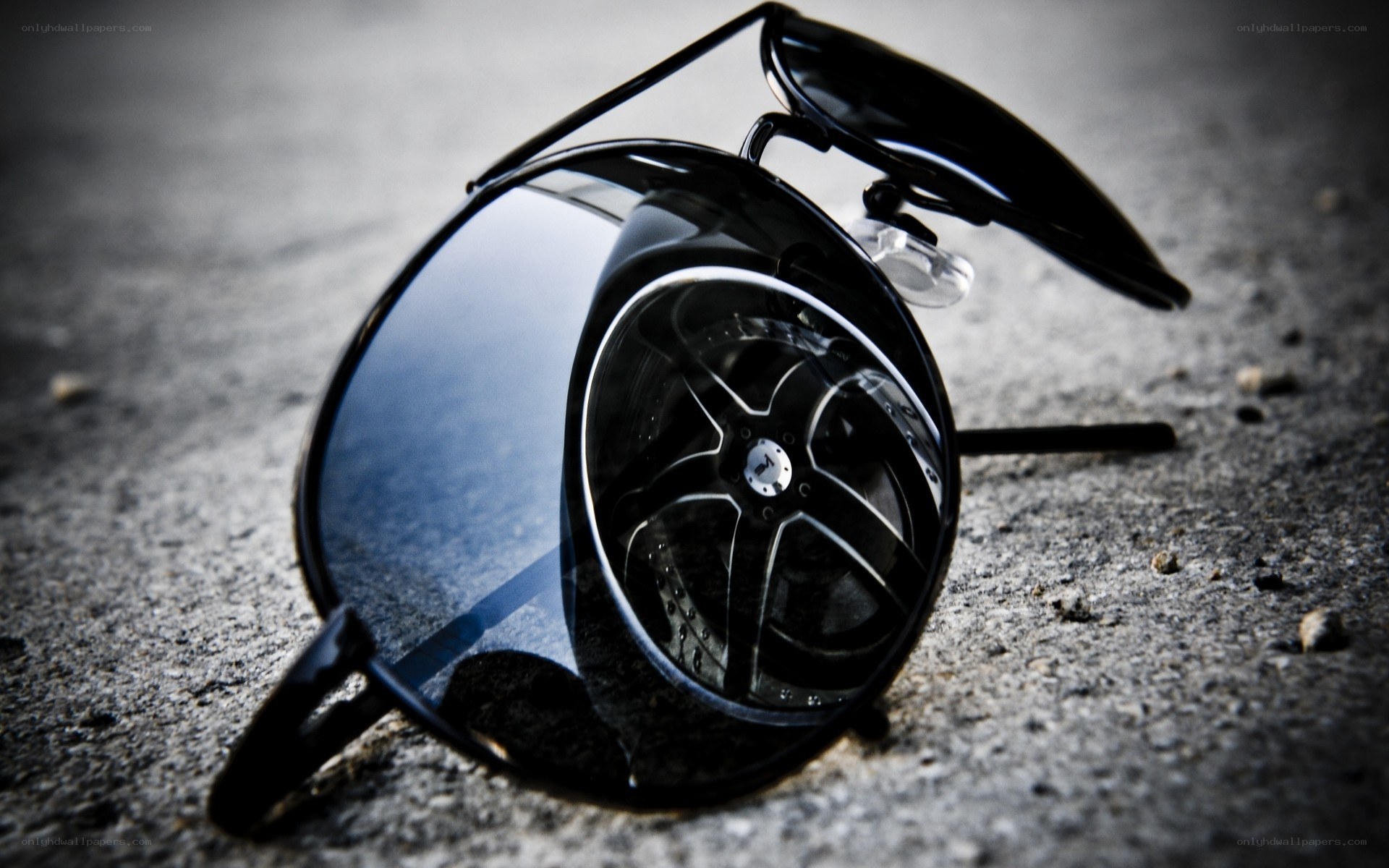 sunglasses on concrete ground