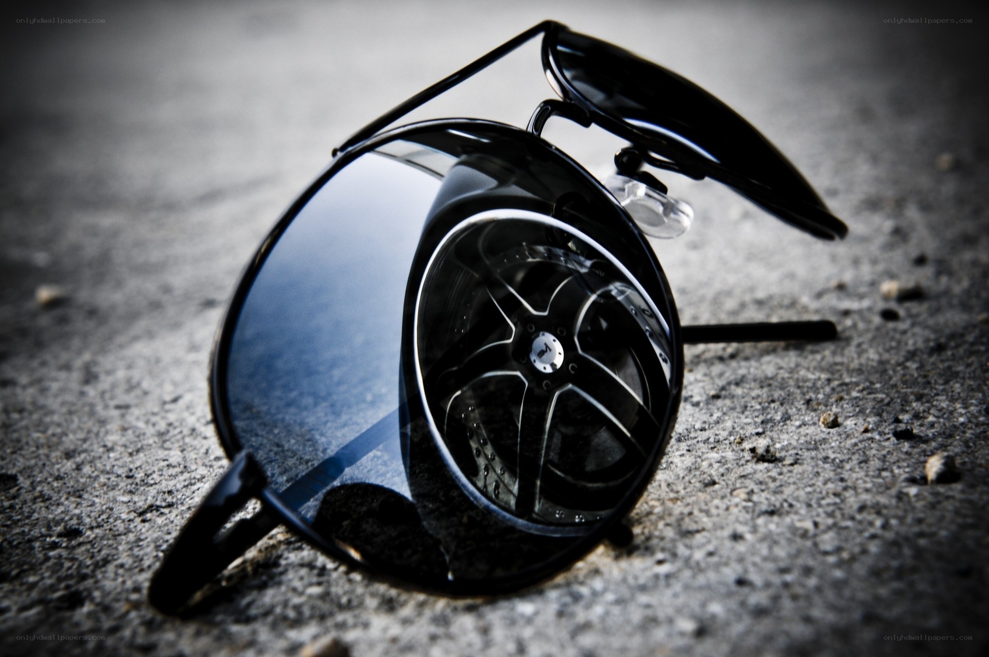 sunglasses on concrete surface