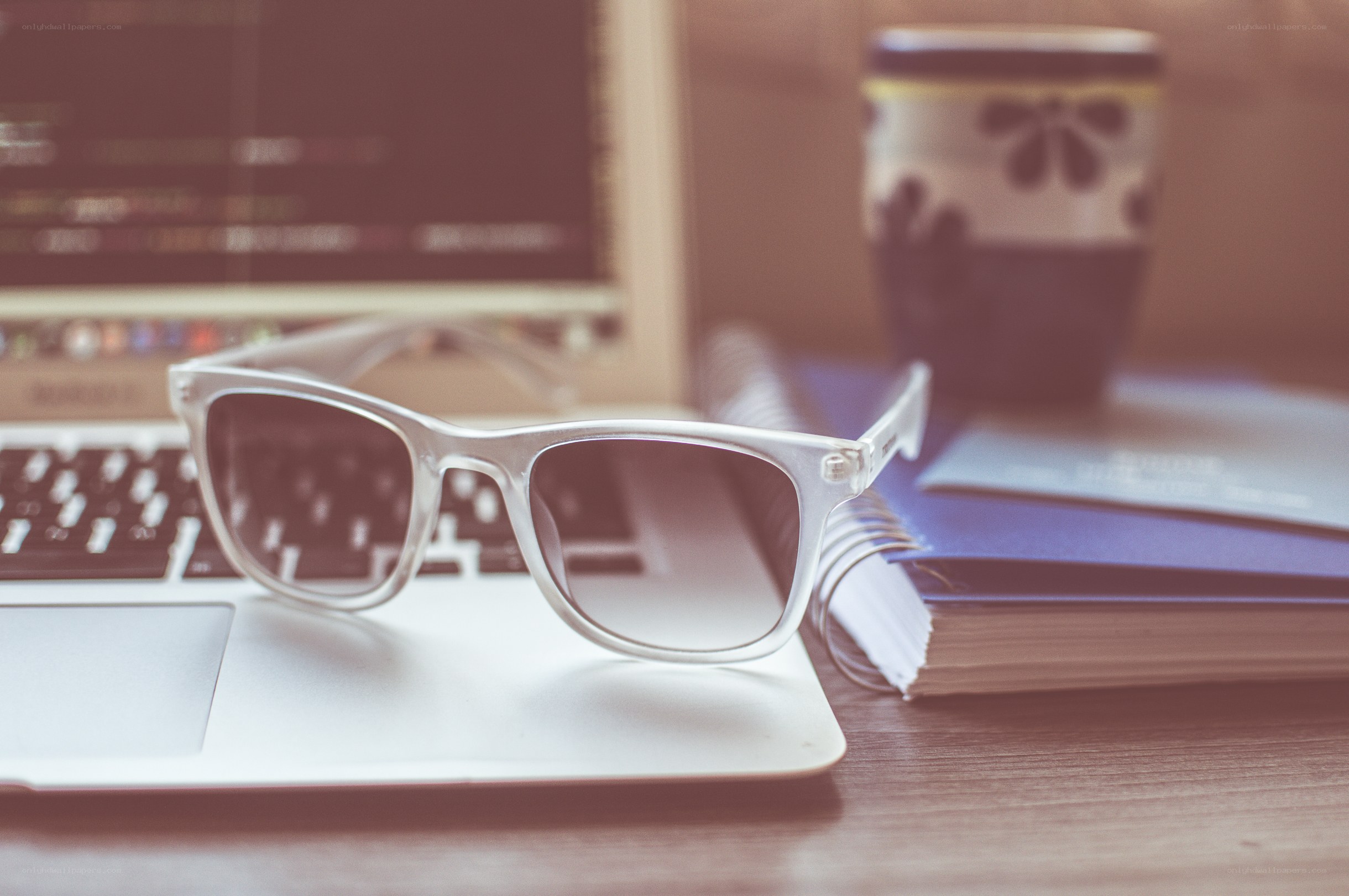 sunglasses on laptop desk