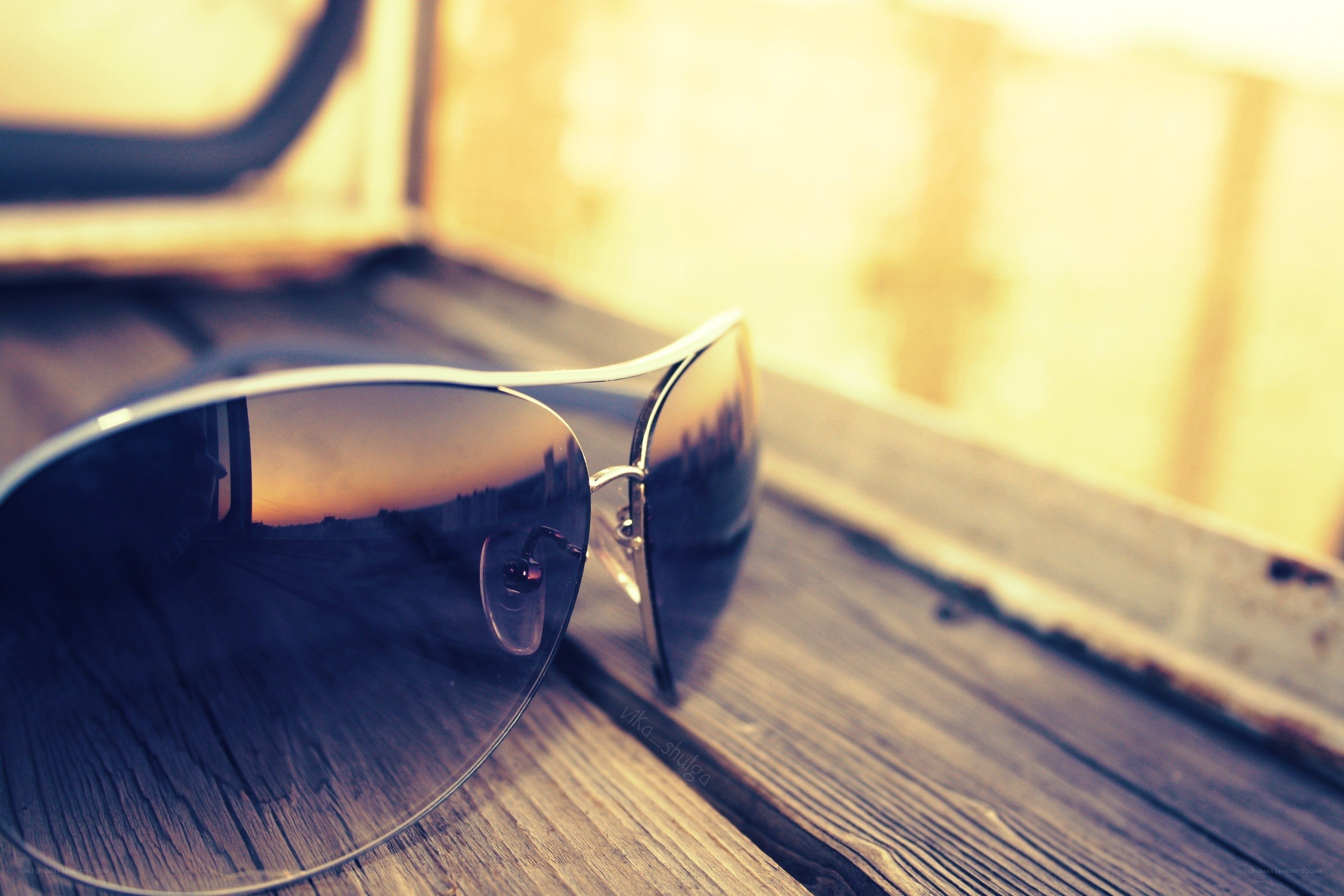 sunglasses on wooden surface