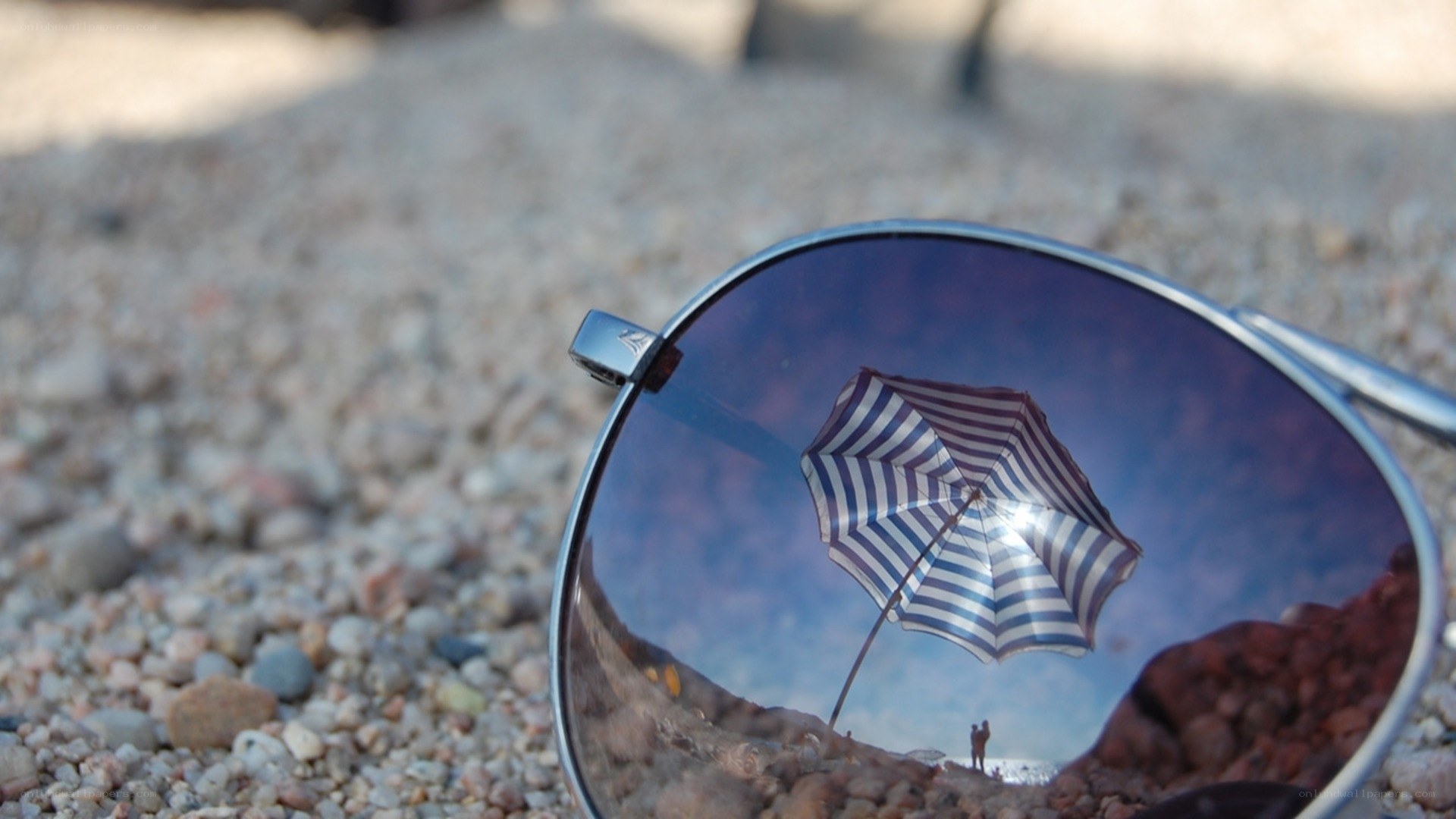 Sunglasses reflect beach umbrella