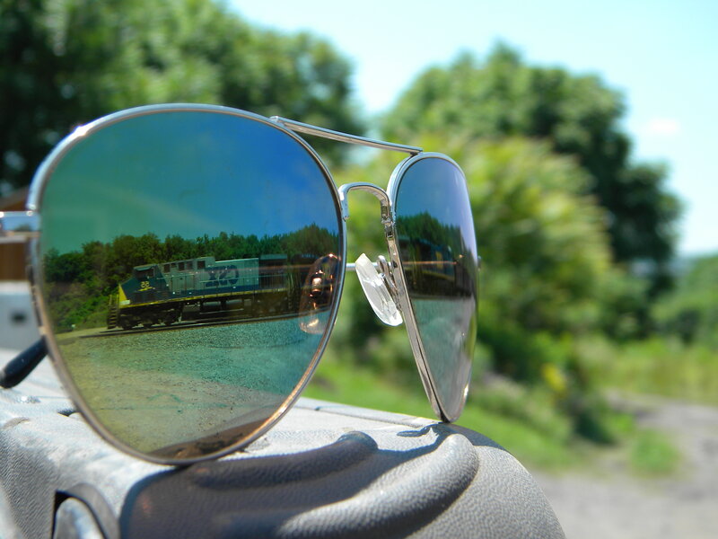 sunglasses reflecting a train