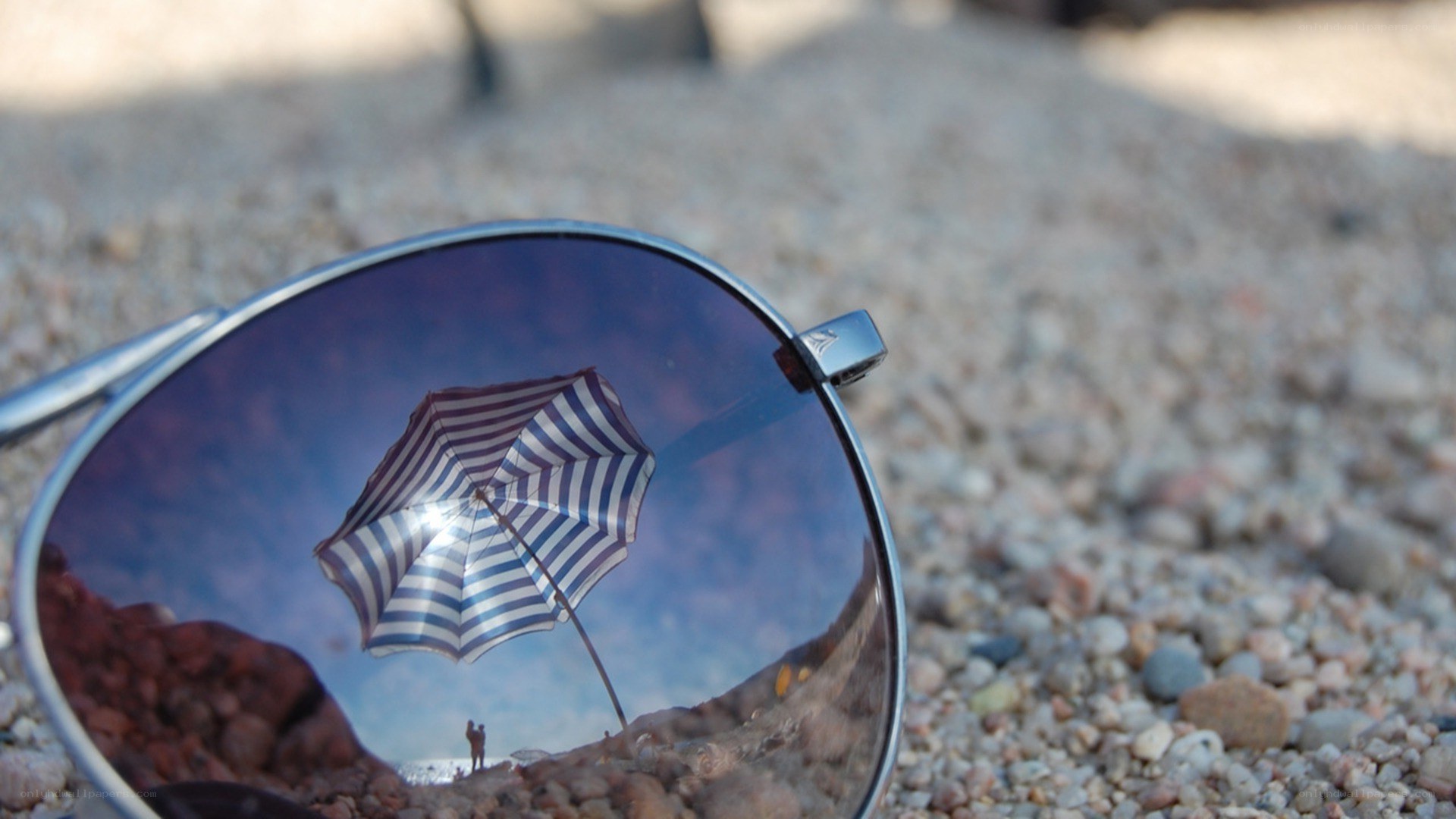 sunglasses reflecting beach scene