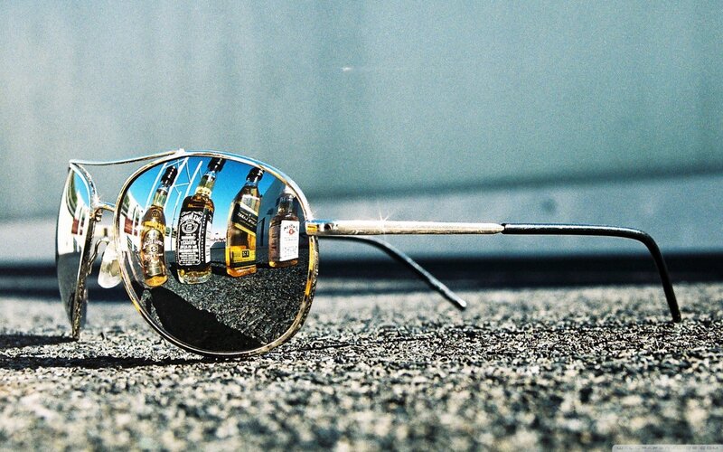 sunglasses reflecting liquor bottles