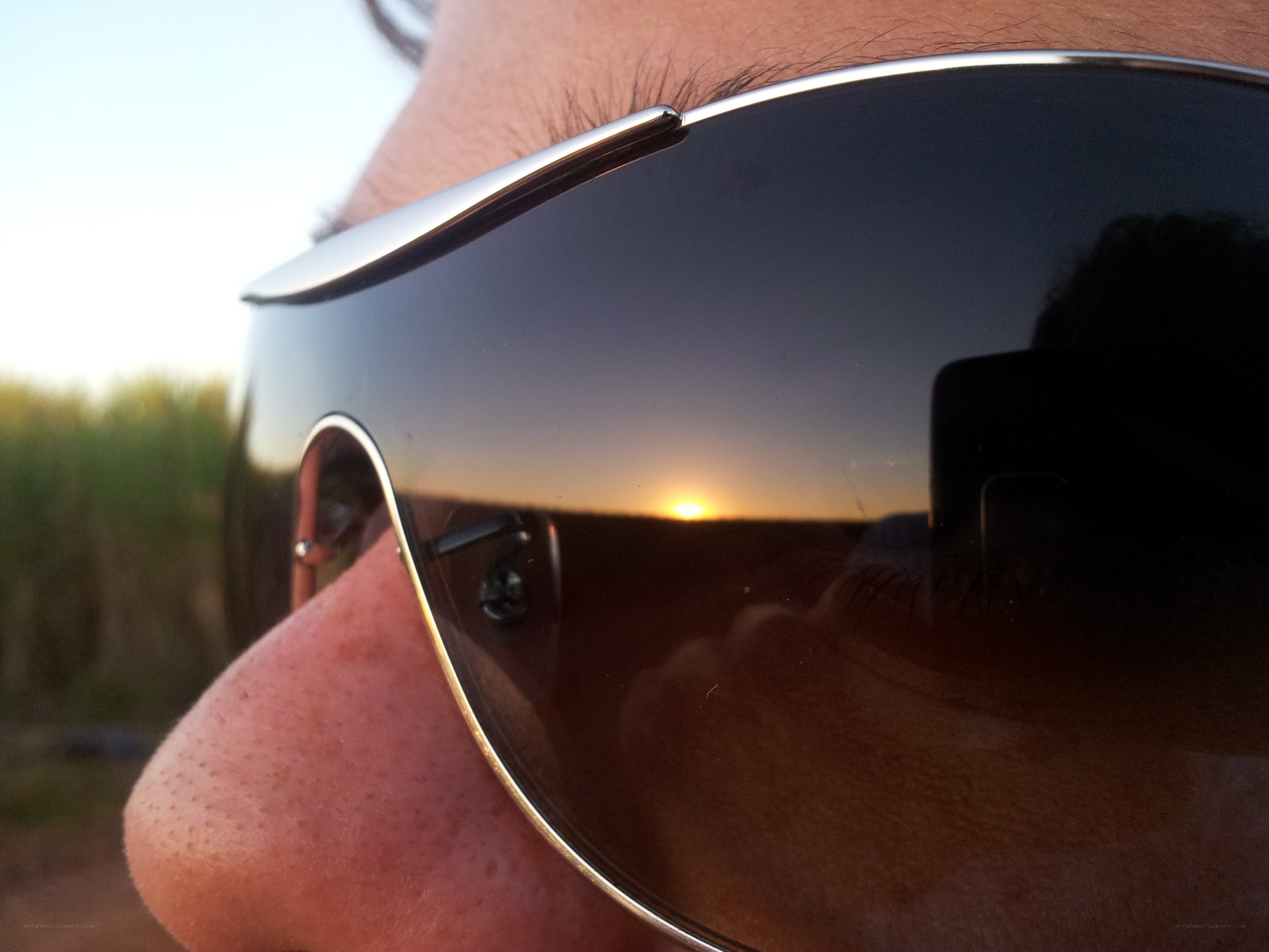 sunglasses reflecting sunset