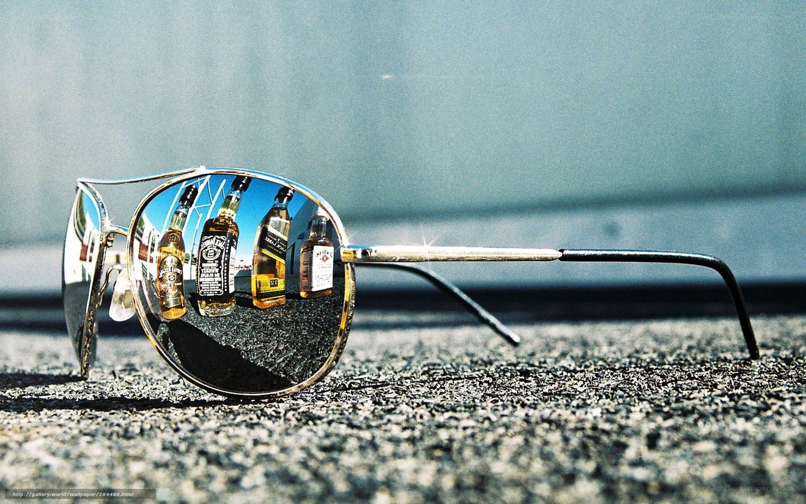sunglasses reflecting whiskey bottles