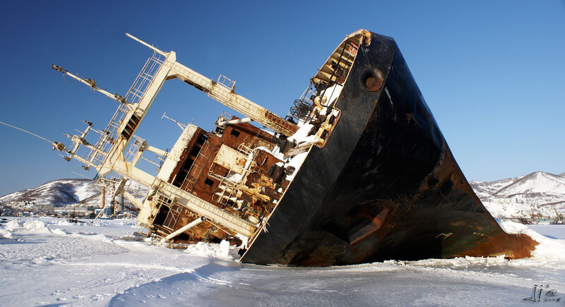 Sunk ship in icy harbor
