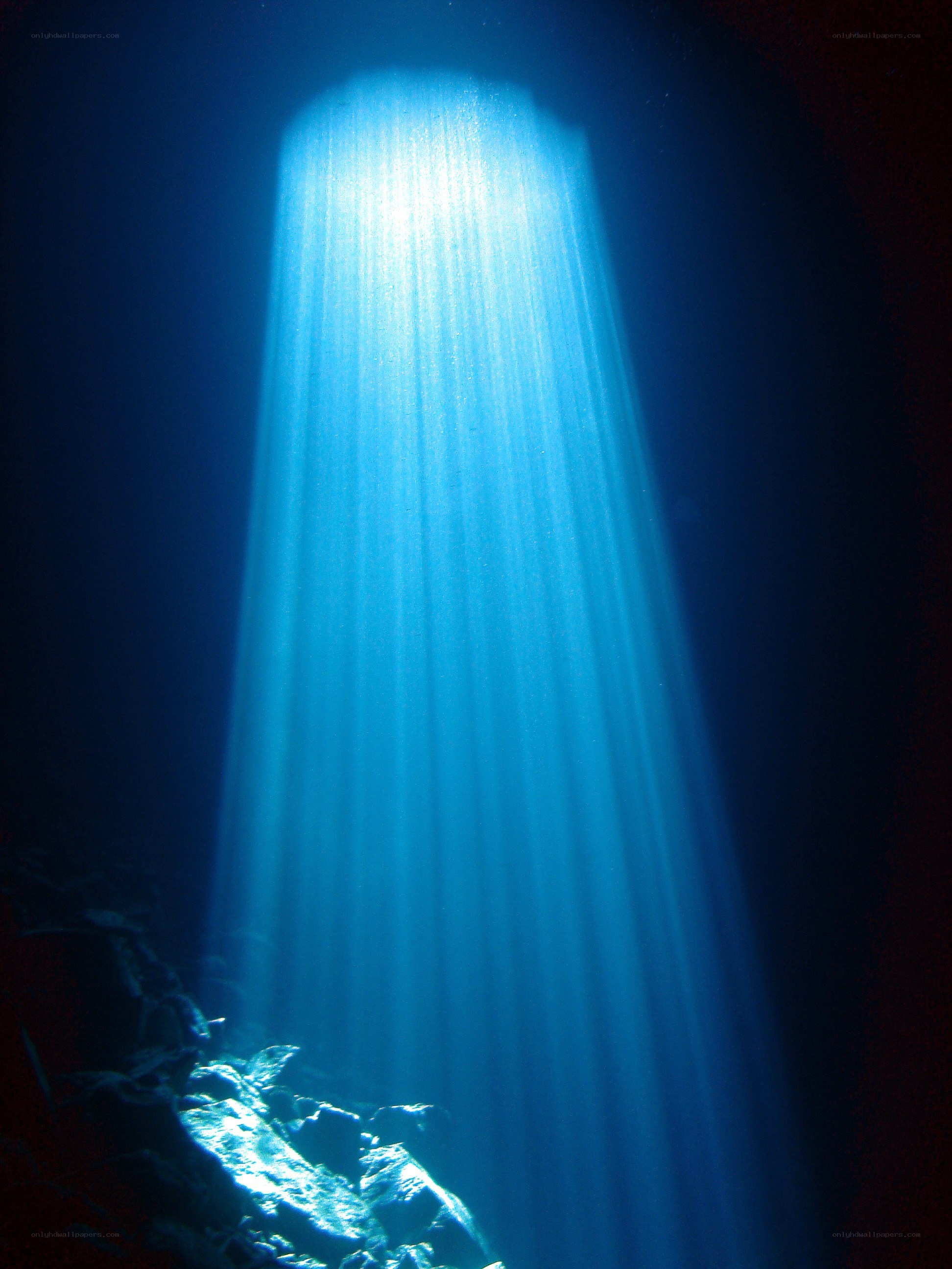 Sunlight beams in underwater cave