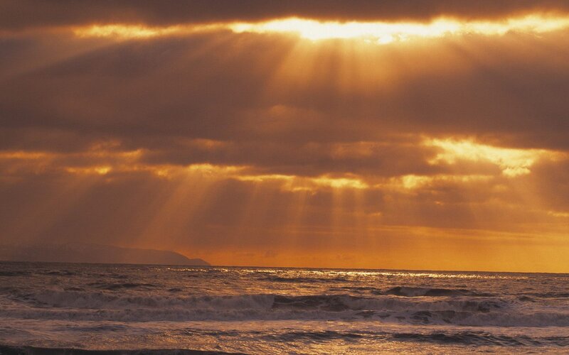 Sunlight beams over ocean