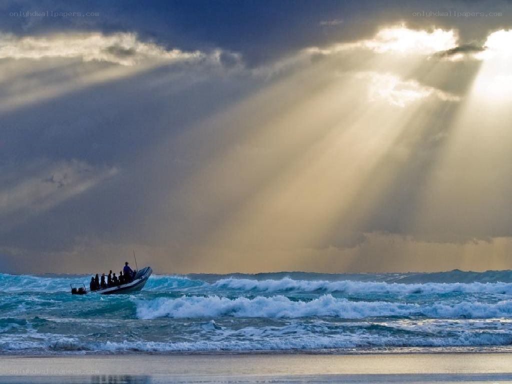 Sunlight beams over ocean boat
