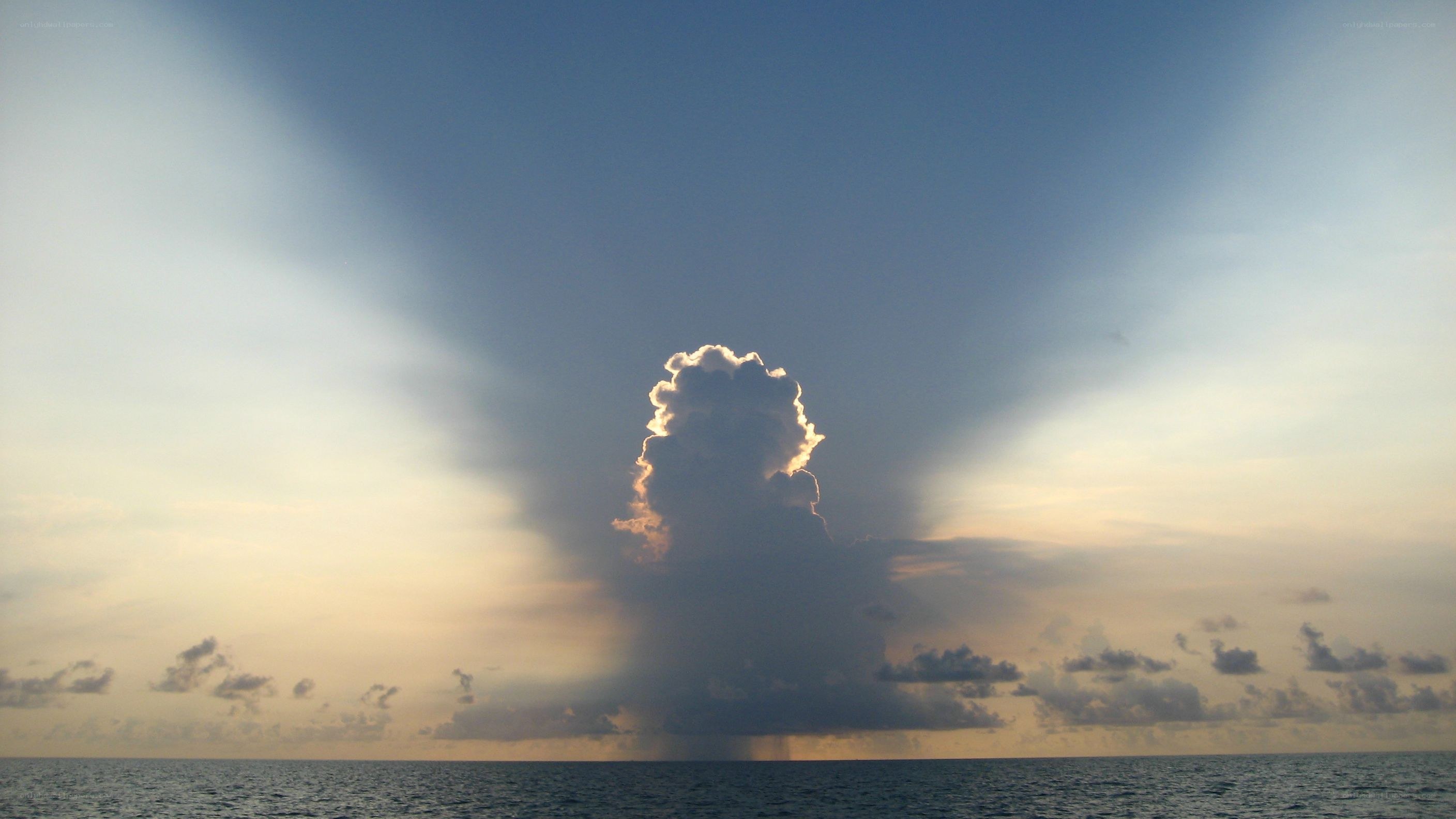 Sunlight beams over ocean cloud