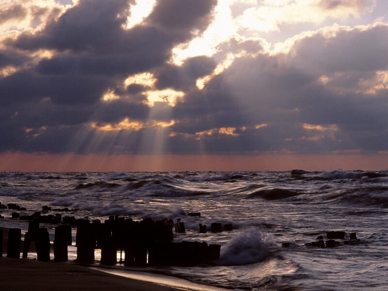 Sunlight beams over ocean waves
