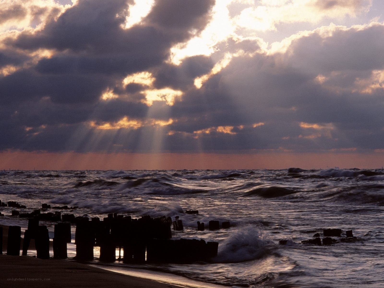 Sunlight beams over ocean waves