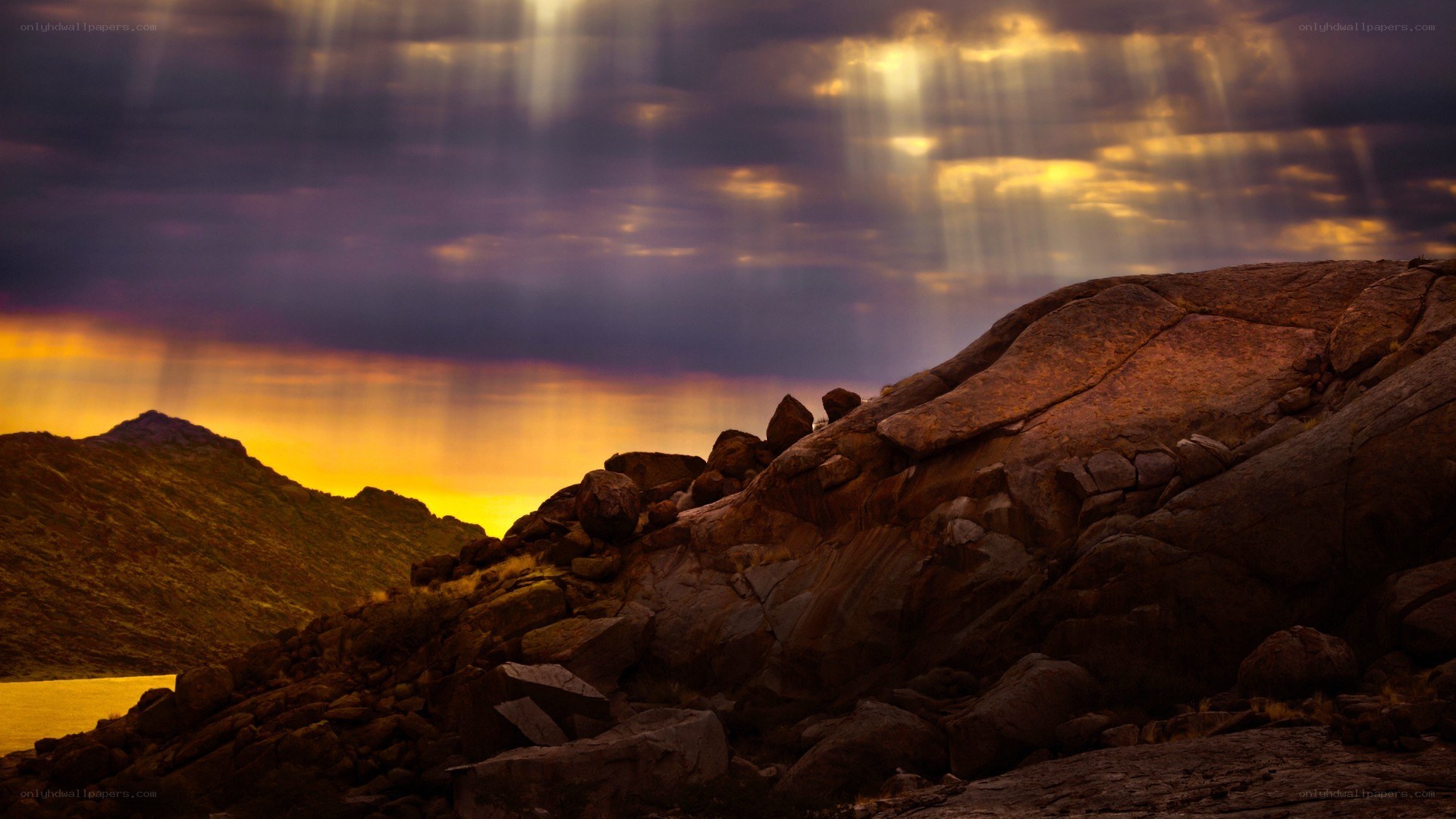 Sunlight beams over rocky landscape