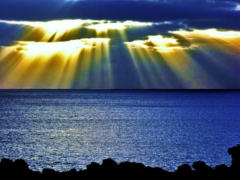 Sunlight beams over the ocean