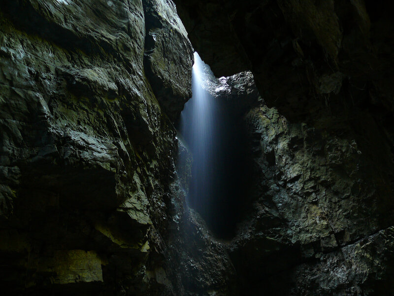 Sunlight beams through cave opening