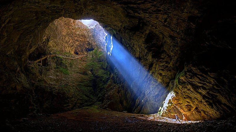 Sunlight beams through cave opening