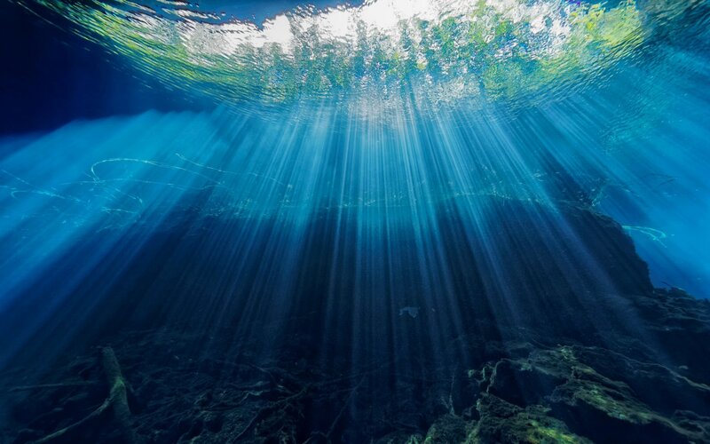 Sunlight Beams Underwater — Blue, Serene, Photograph, Water Surface, Rocks