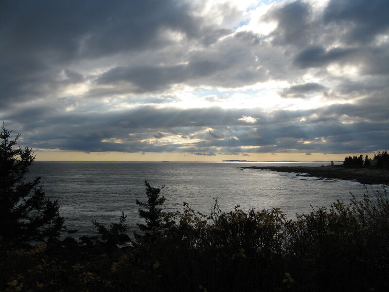 Sunlight breaks through clouds over the sea