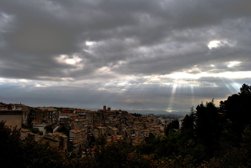 Sunlight breaks through clouds over town