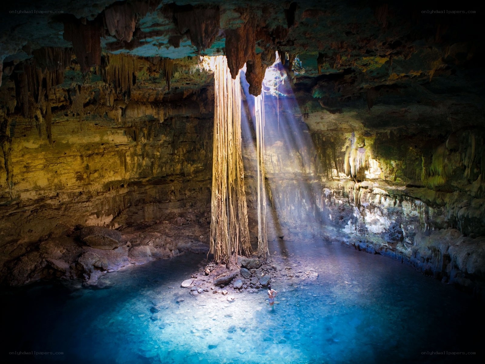 Sunlight in a cave with a cenote
