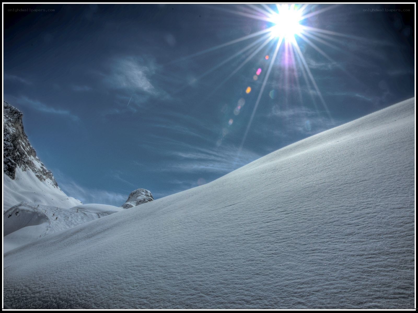 Sunlight on a snowy mountain slope