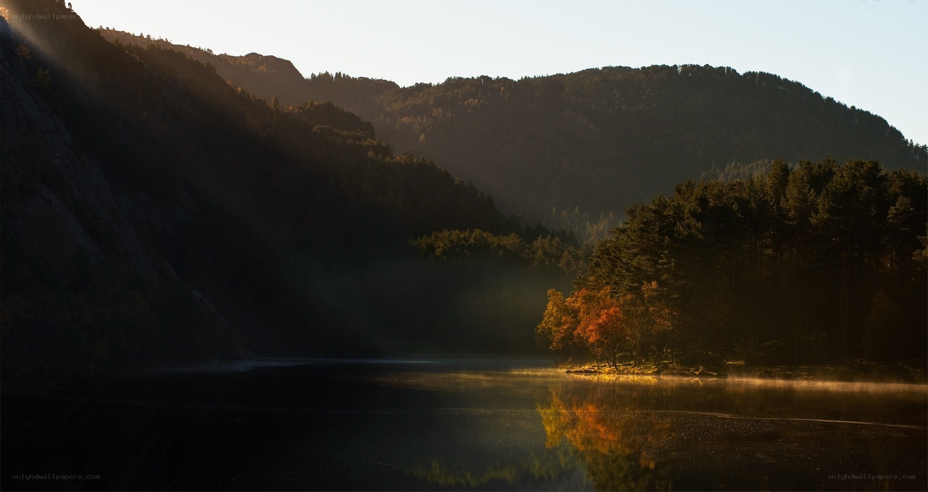 Sunlight over a misty lake