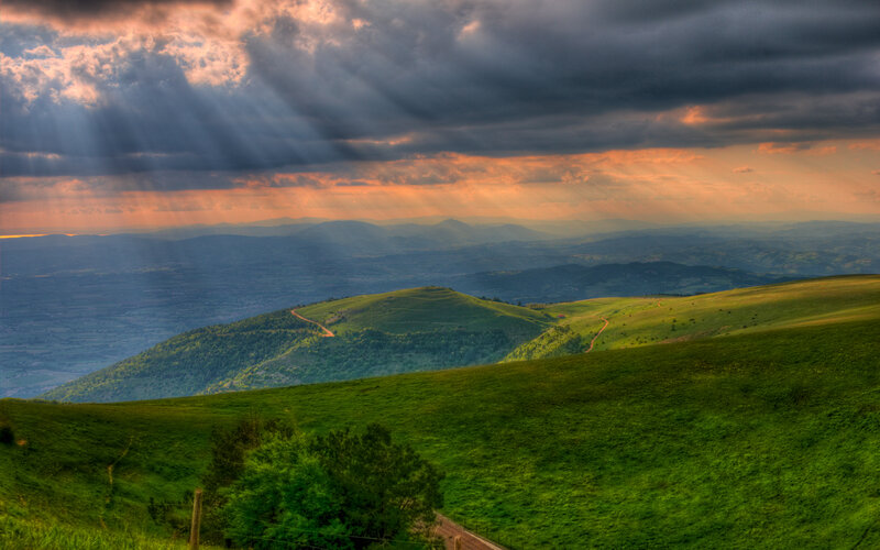 Sunlight over green hills