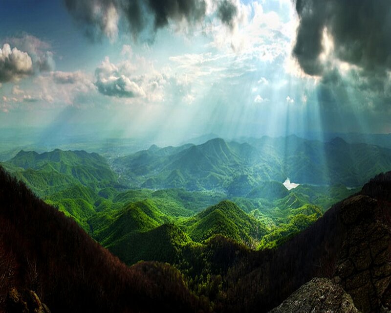 Sunlight over green mountains