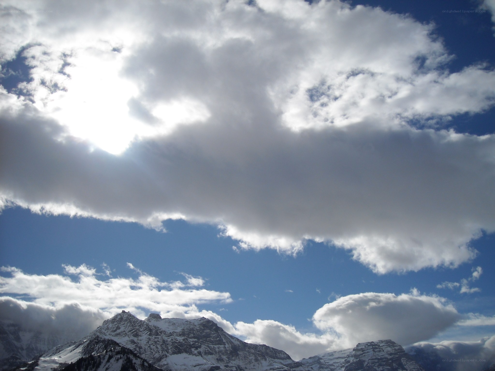 Sunlight over snow-capped mountains