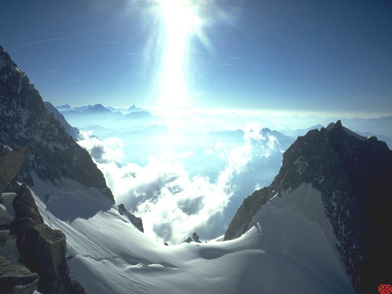 Sunlight over snowy mountain peaks