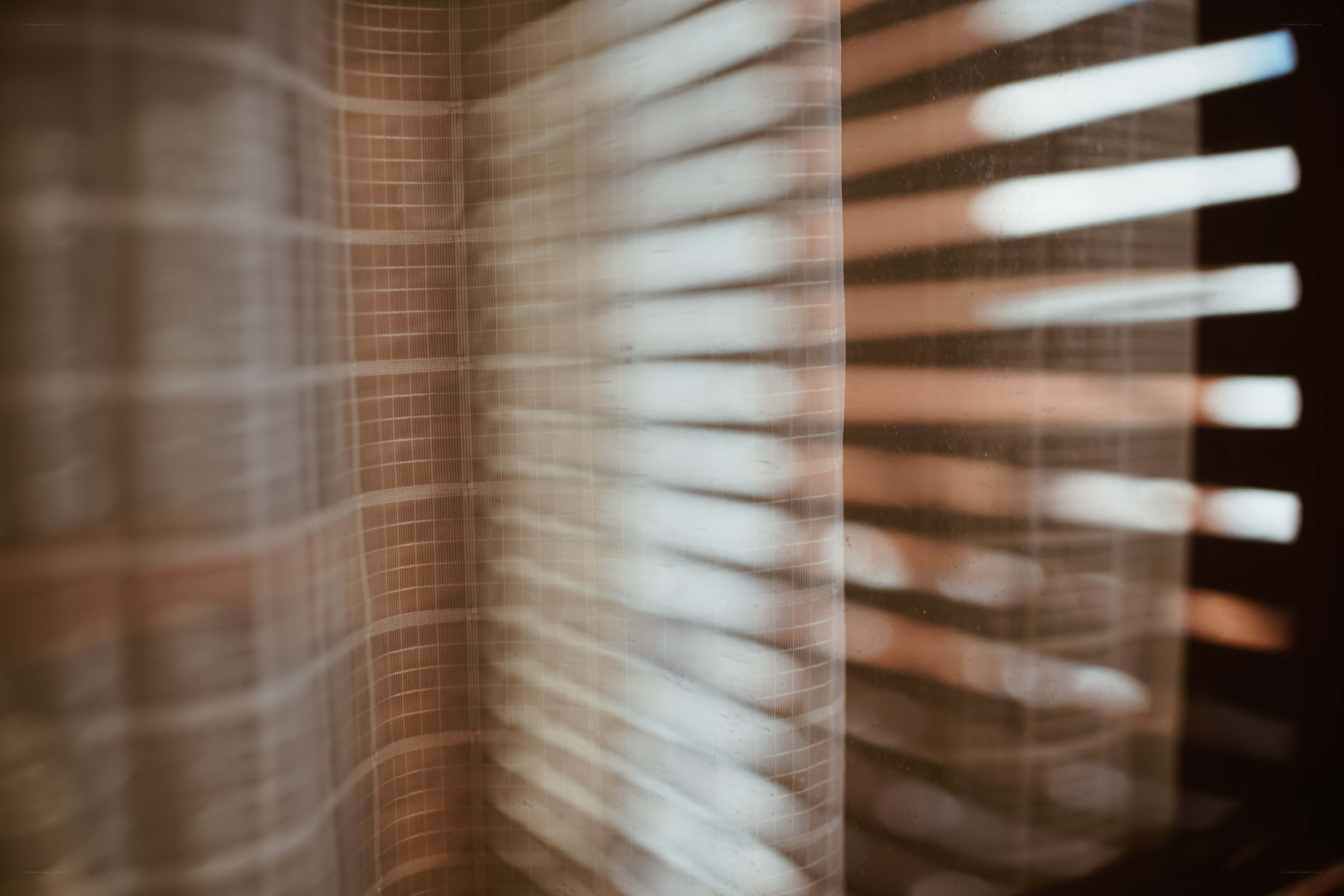 Sunlight through a sheer curtain