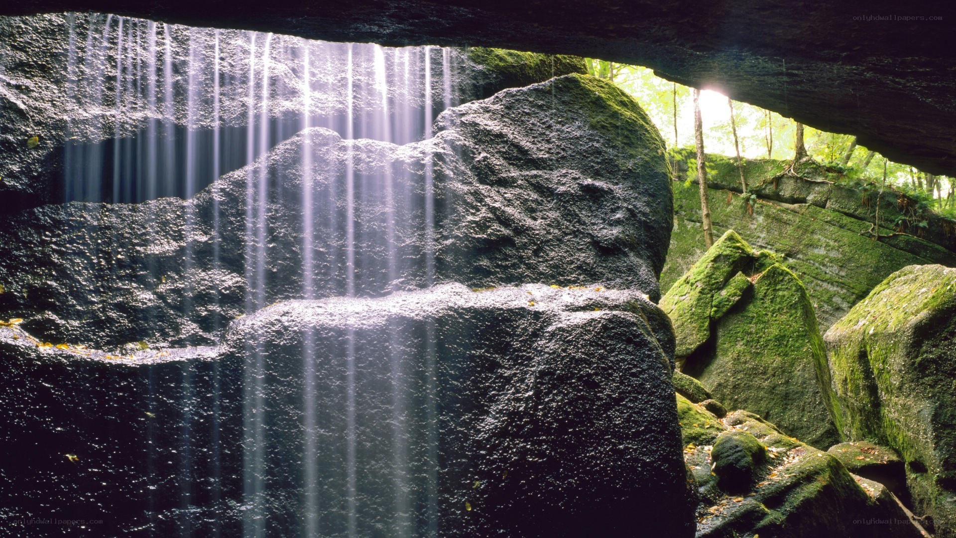 Sunlight through cave waterfall
