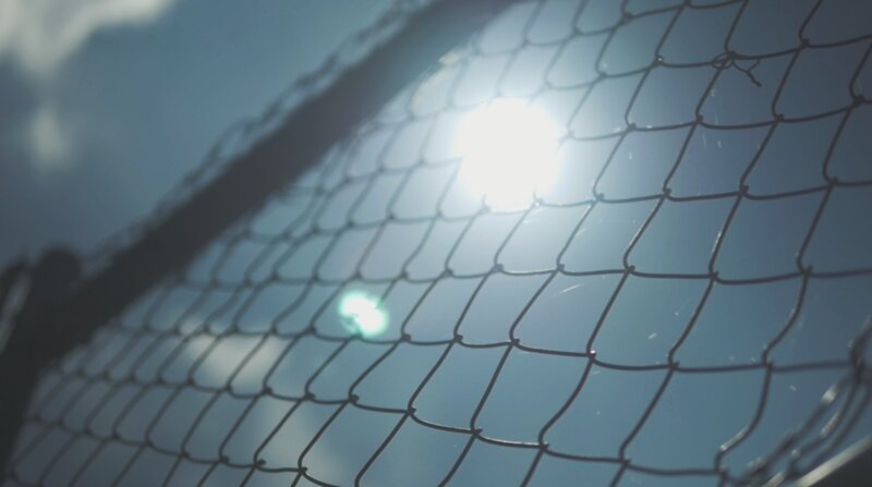 Sunlight Through Chain-link Fence — Blue