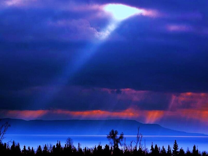 Sunlight Through Clouds — Blue, Dramatic, Sunset, Photograph, Mountains, Trees, Purple