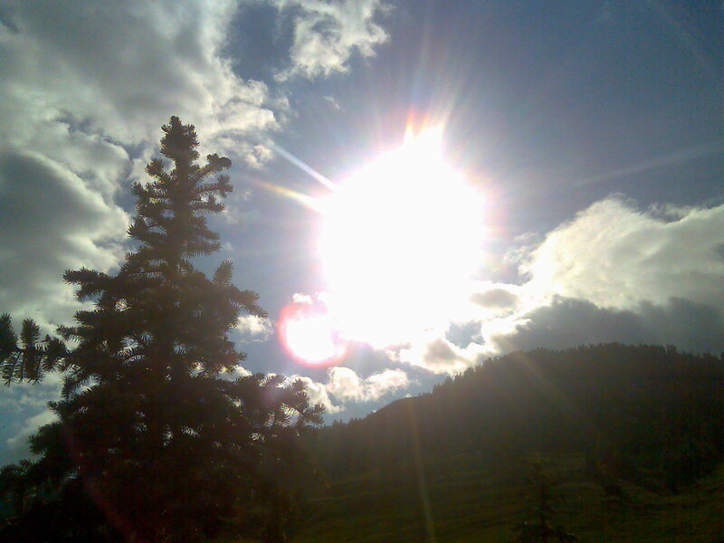 Sunlight through clouds over a forest