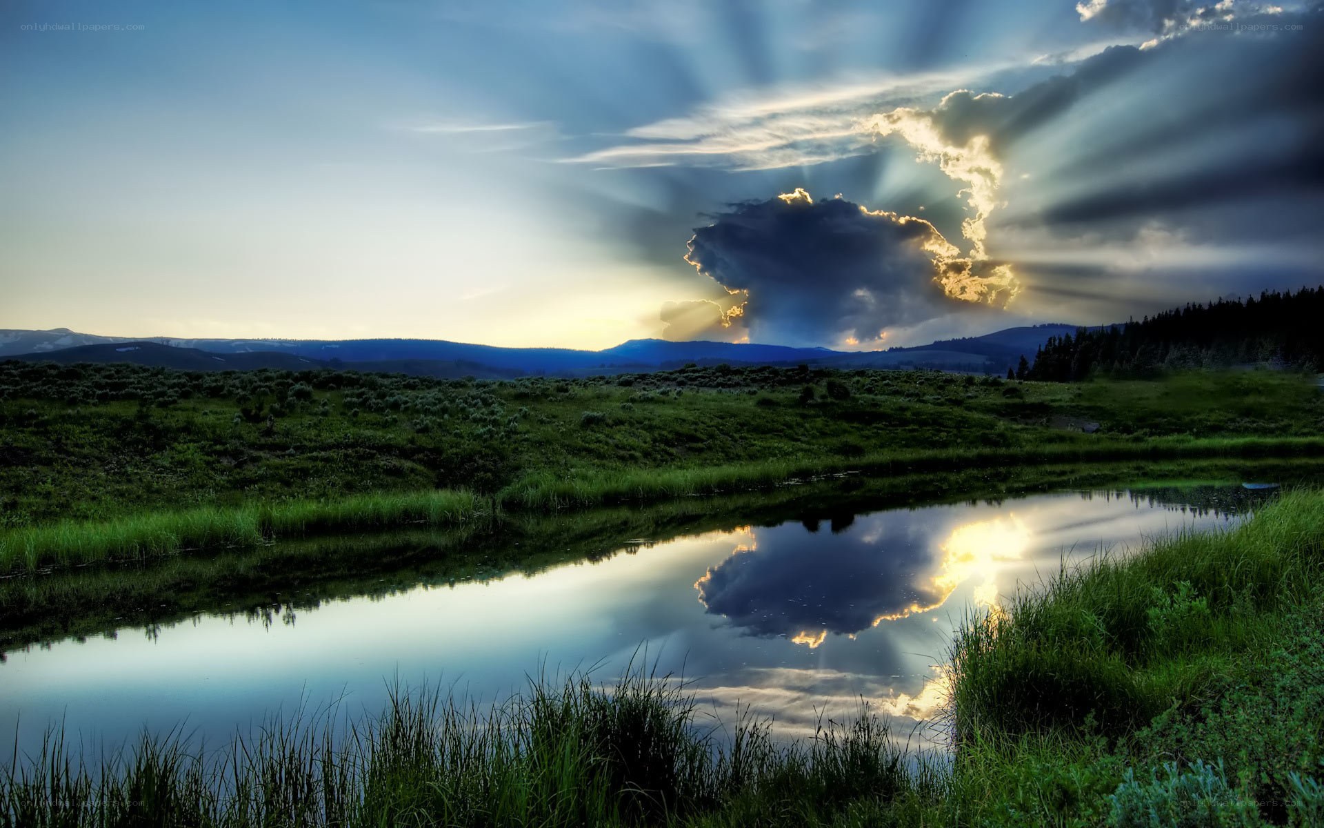 Sunlight through clouds over a pond