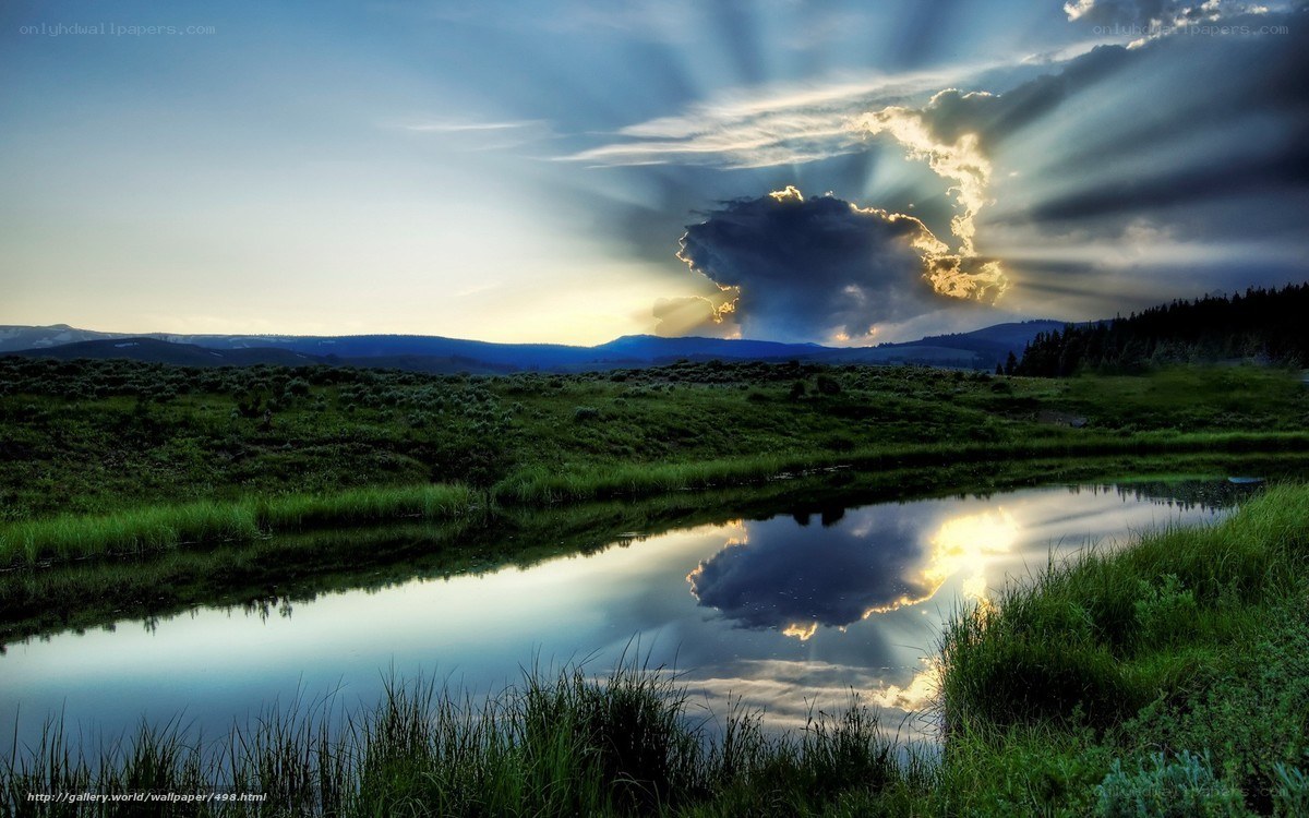 Sunlight through clouds over a pond