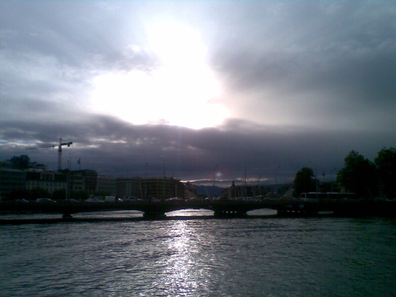 Sunlight through clouds over a river