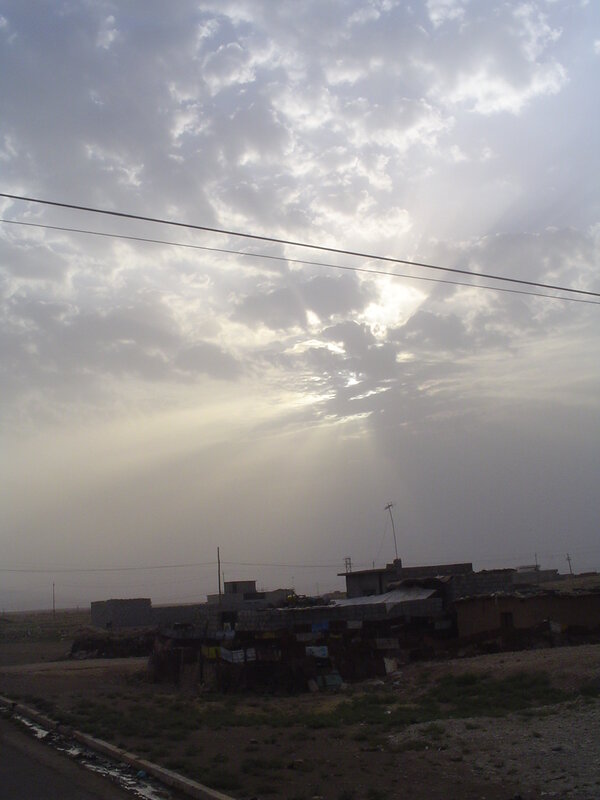 Sunlight through clouds over a village
